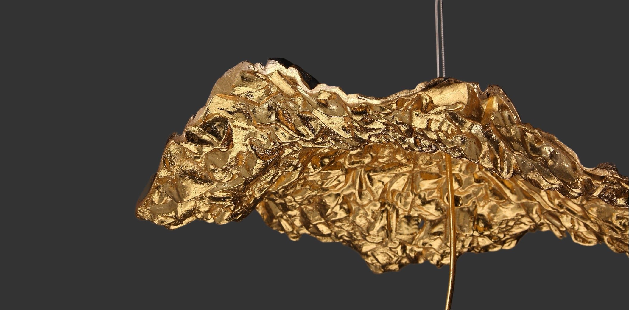 Close up of VORELLI Obscura staircase chandelier with sculptural textured form