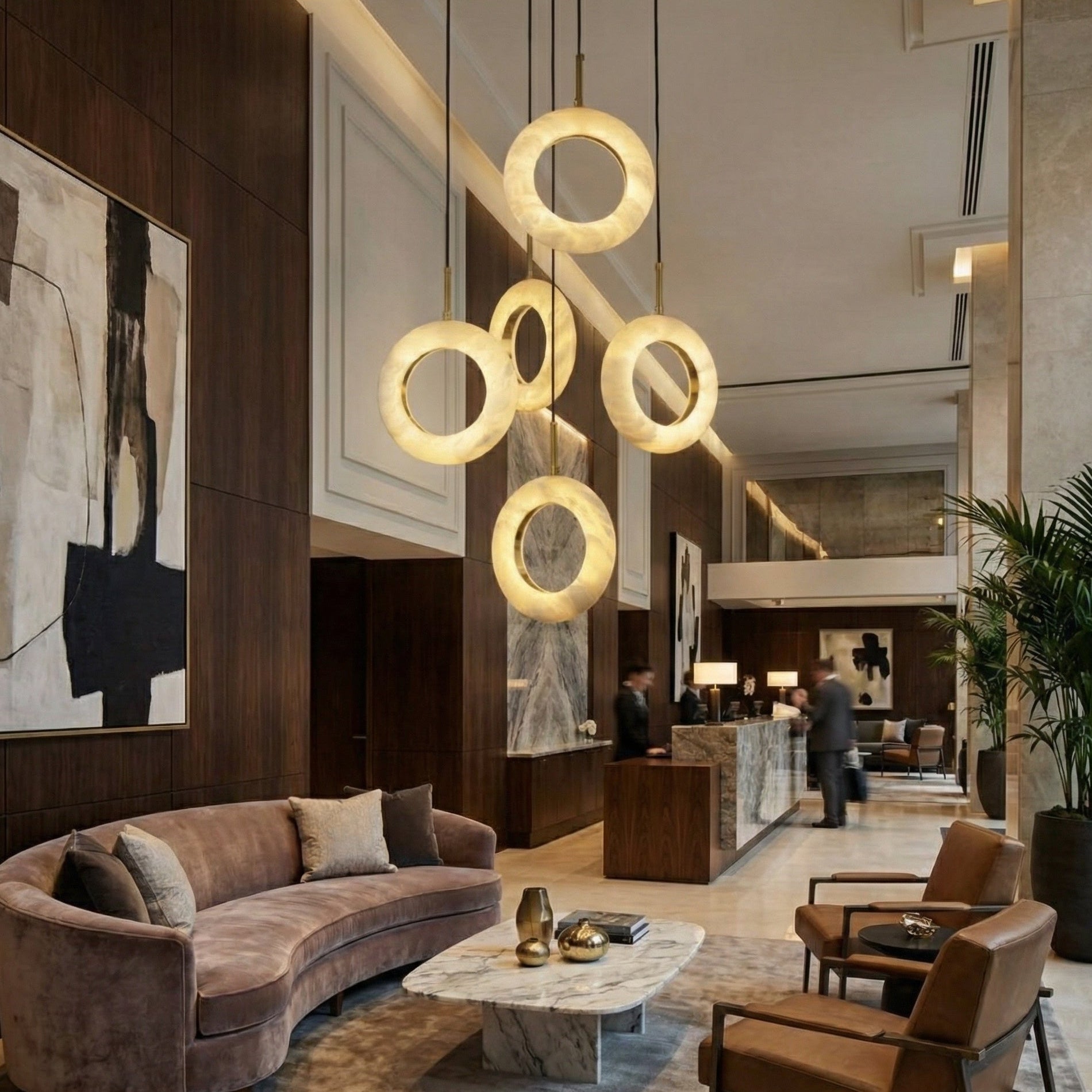 Designer Pietra staircase chandelier creating warm ambient glow in modern luxury home
