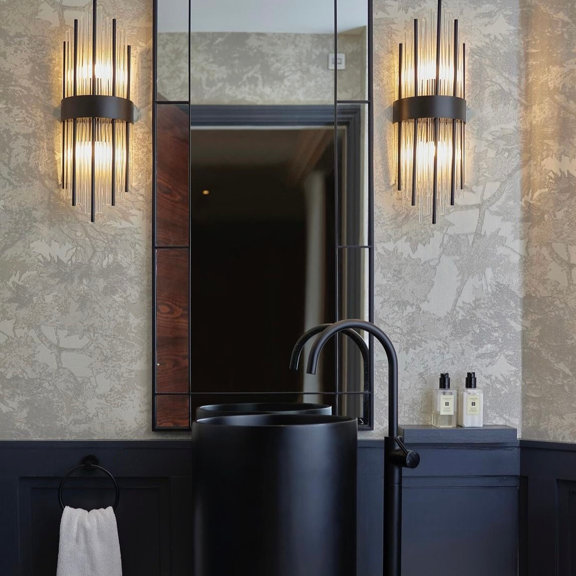Piper Point modern cylinder wall sconce installed in contemporary bathroom interior