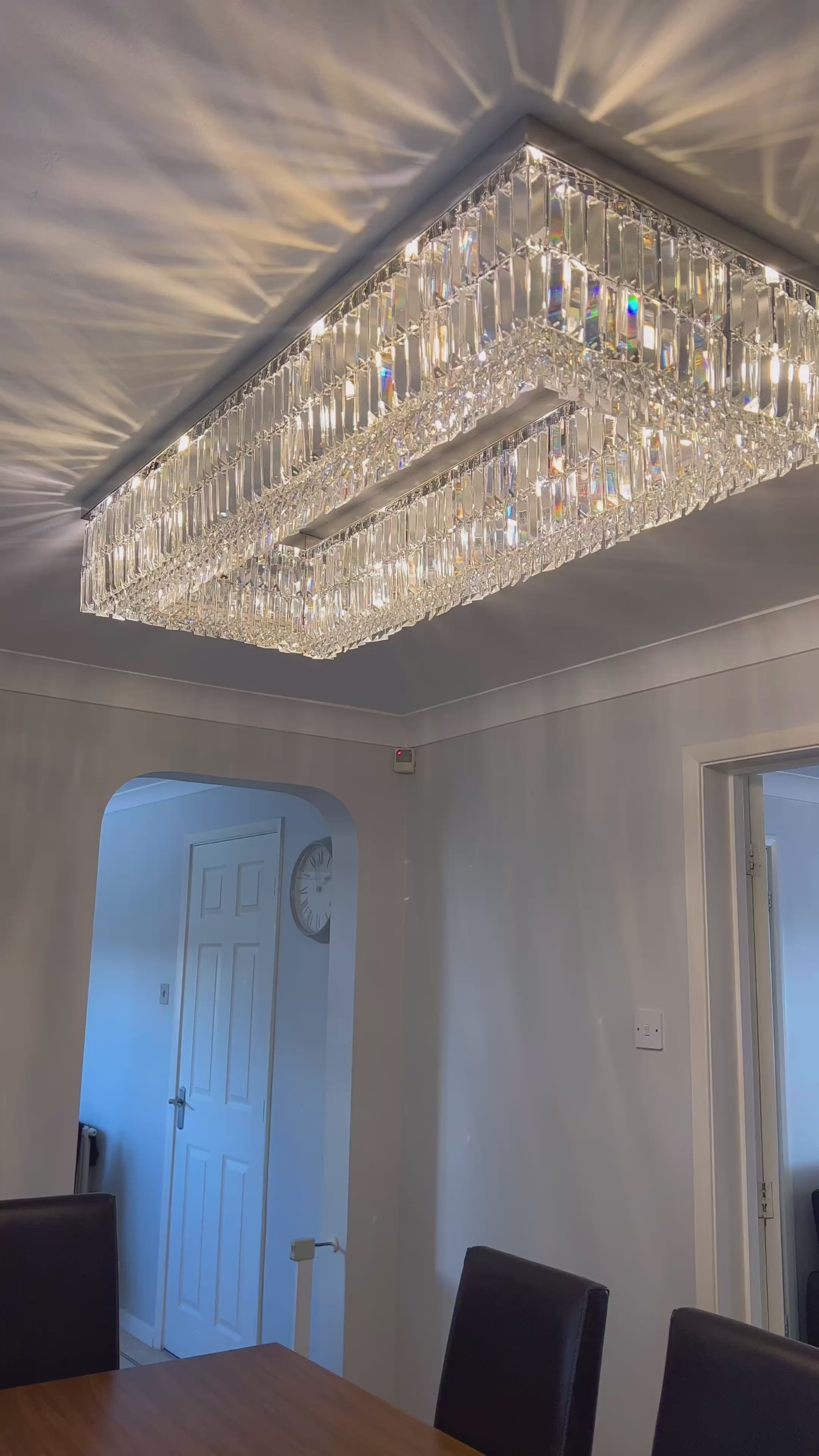 Rectangular crystal ceiling light featuring diamond cut faceted crystals creating refined ambient lighting