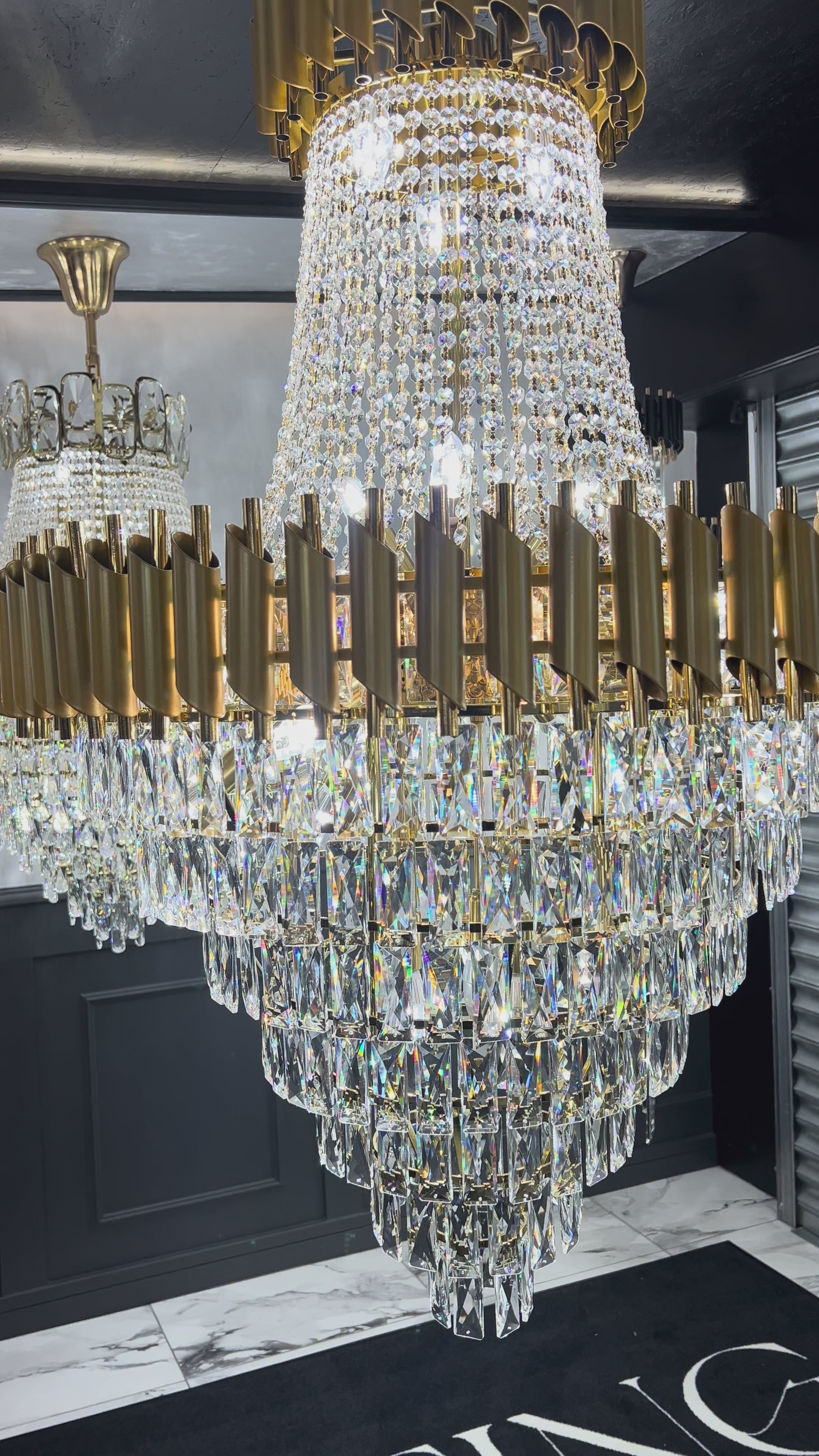 Illuminated diamond-cut crystal cascade detail on the VORELLI Milltimber Grandeur staircase chandelier