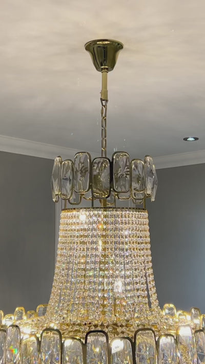 Elegant Edison Grandeur crystal staircase chandelier illuminating a multi-level luxury home by VORELLI®