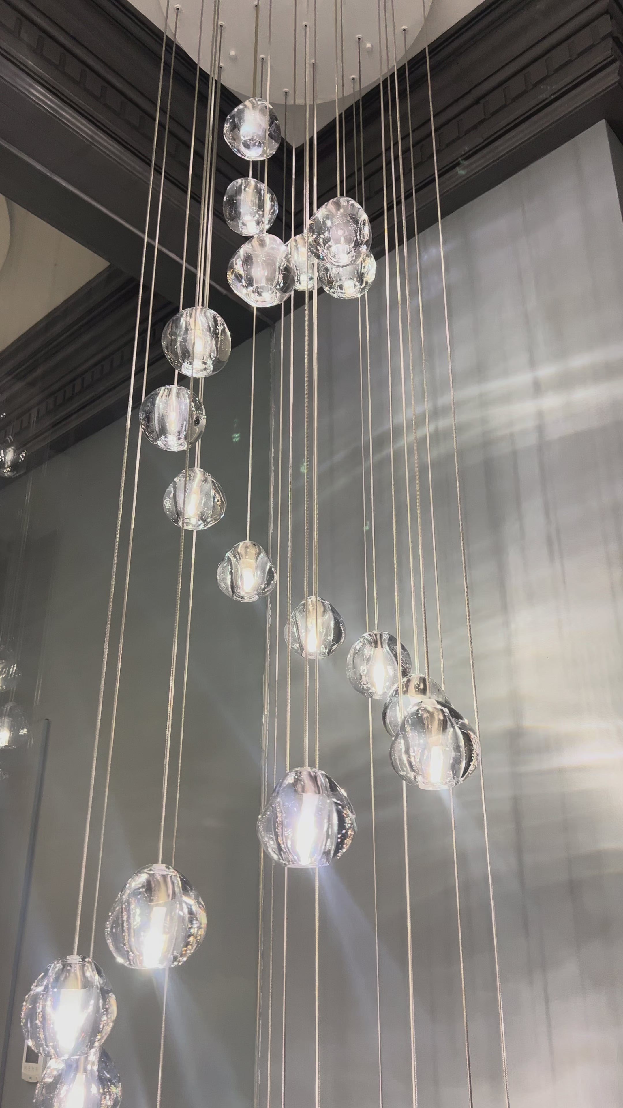 Biella pendant staircase chandelier featuring cascading crystal pendants creating a dramatic luxury lighting statement