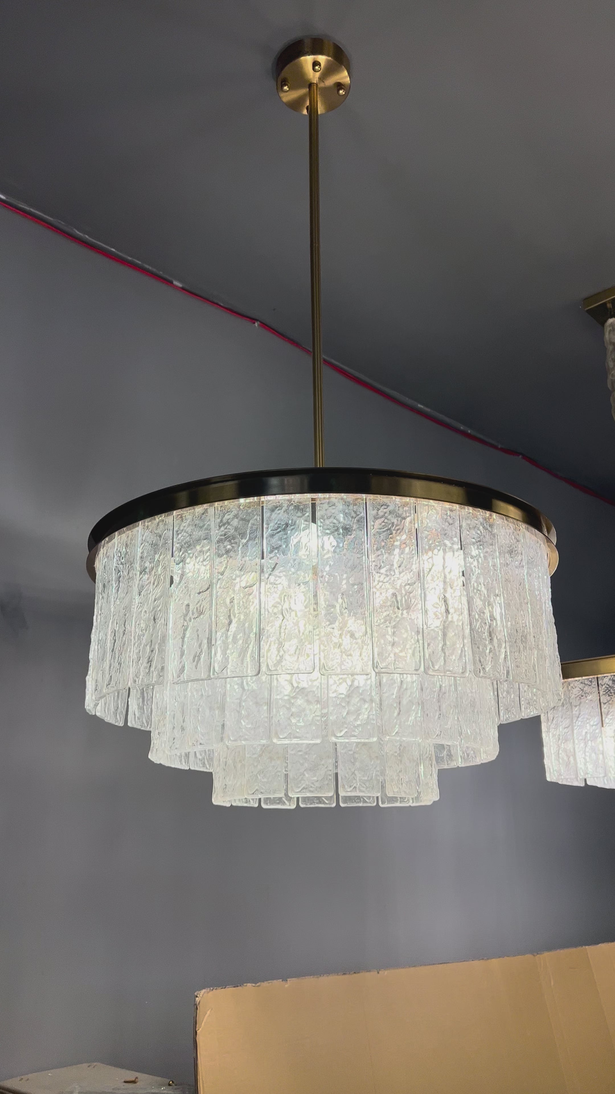 Cellini circular chandelier featuring multiple tiers of cracked textured rectangular crystals, showcasing dramatic luxury lighting for upscale interiors