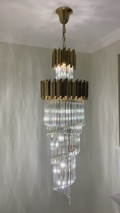 Full-length view of the Boeotia Spiral Staircase Chandelier II with its elegant spiral crystal formation and gold cuboid tubing.