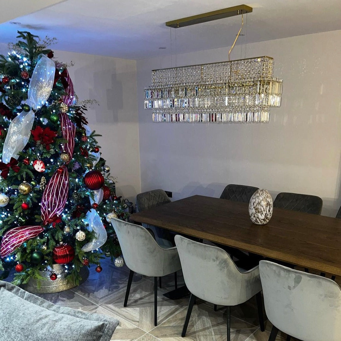 Rectangular crystal chandelier above dining table in UAE villa