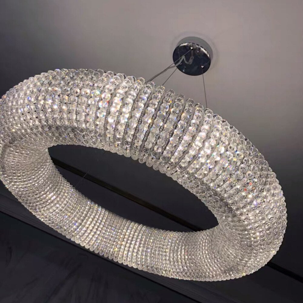 Seminyak luxury halo chandelier showcasing diamond cut crystal pearl detailing around sleek circular frame