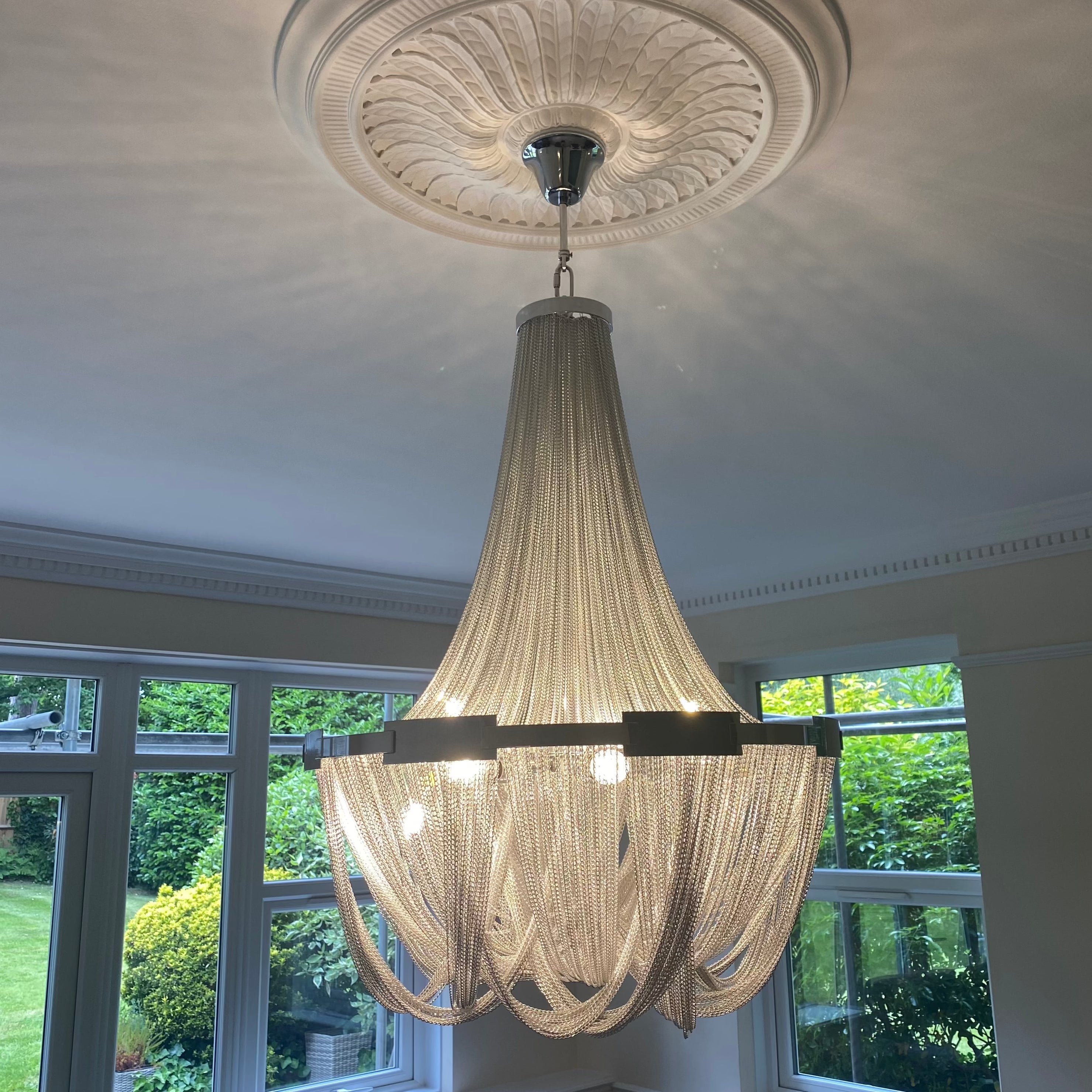 Ceiling mounted cascading chain chandelier detail in UAE home