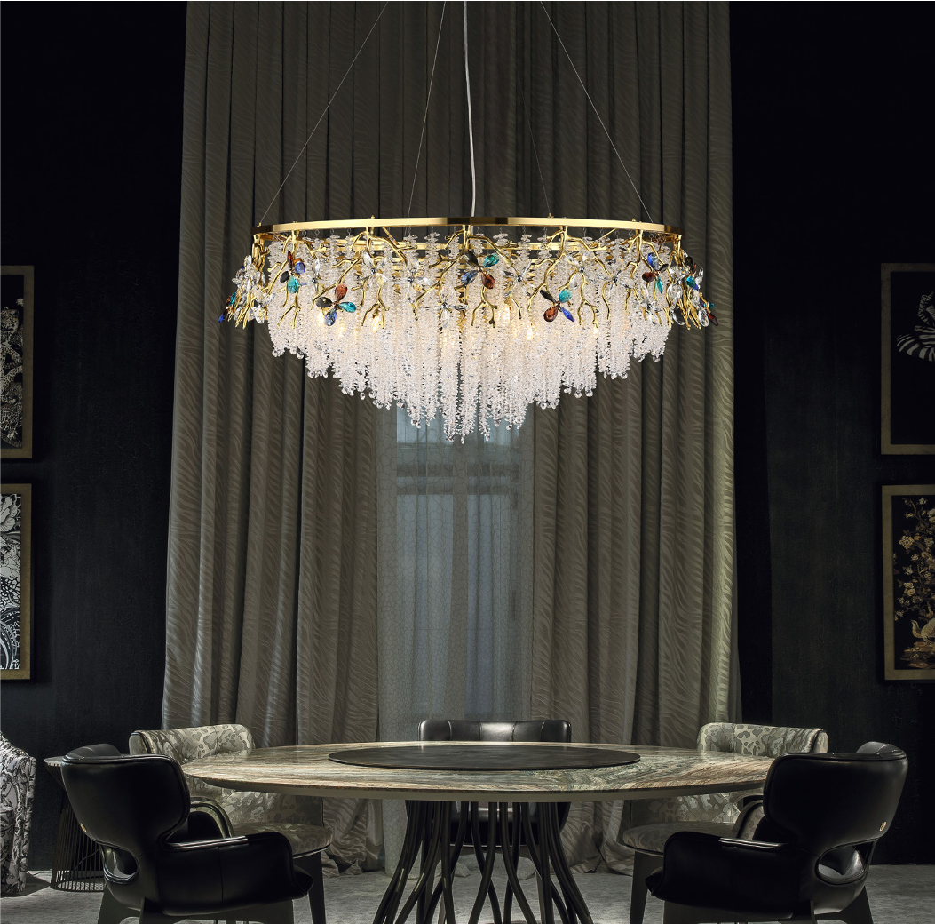 The Wisteria Circular Chandelier II illuminating a luxury residential dining room, casting warm light through cascading glass beads.