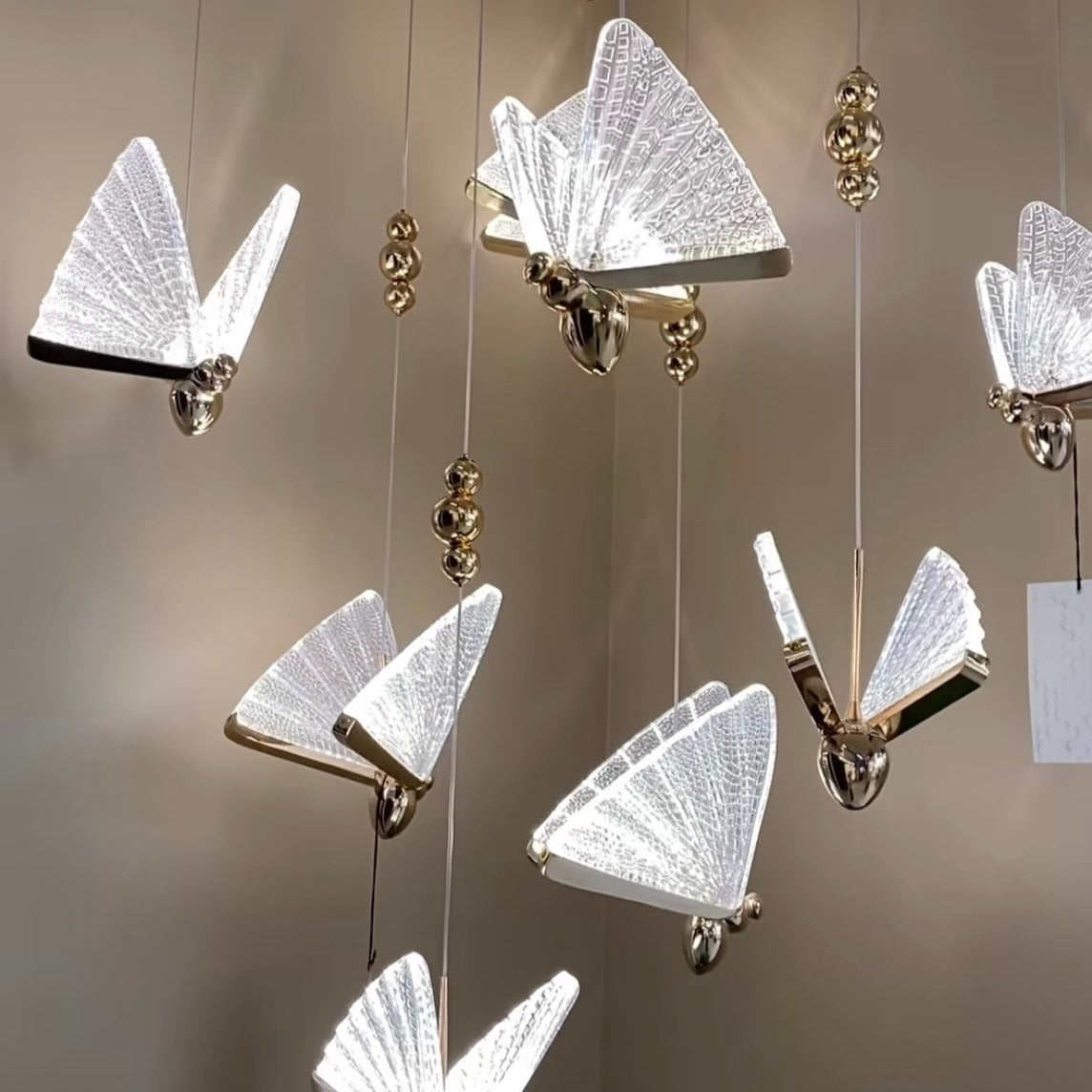 Butterfly Pendant Light suspended above a dining or play area, highlighting its whimsical glass butterfly forms.