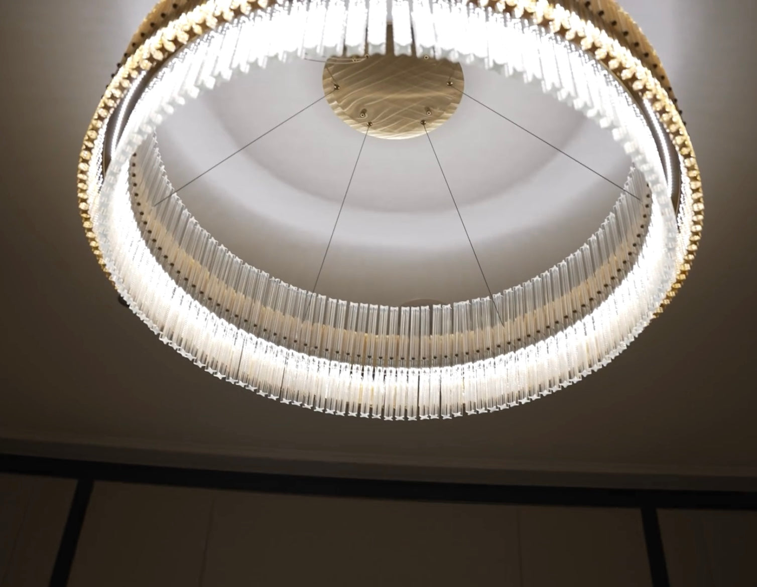 Close-up of VORELLI® Condotti circular chandelier showing diamond-cut crystal detail and ambient glow