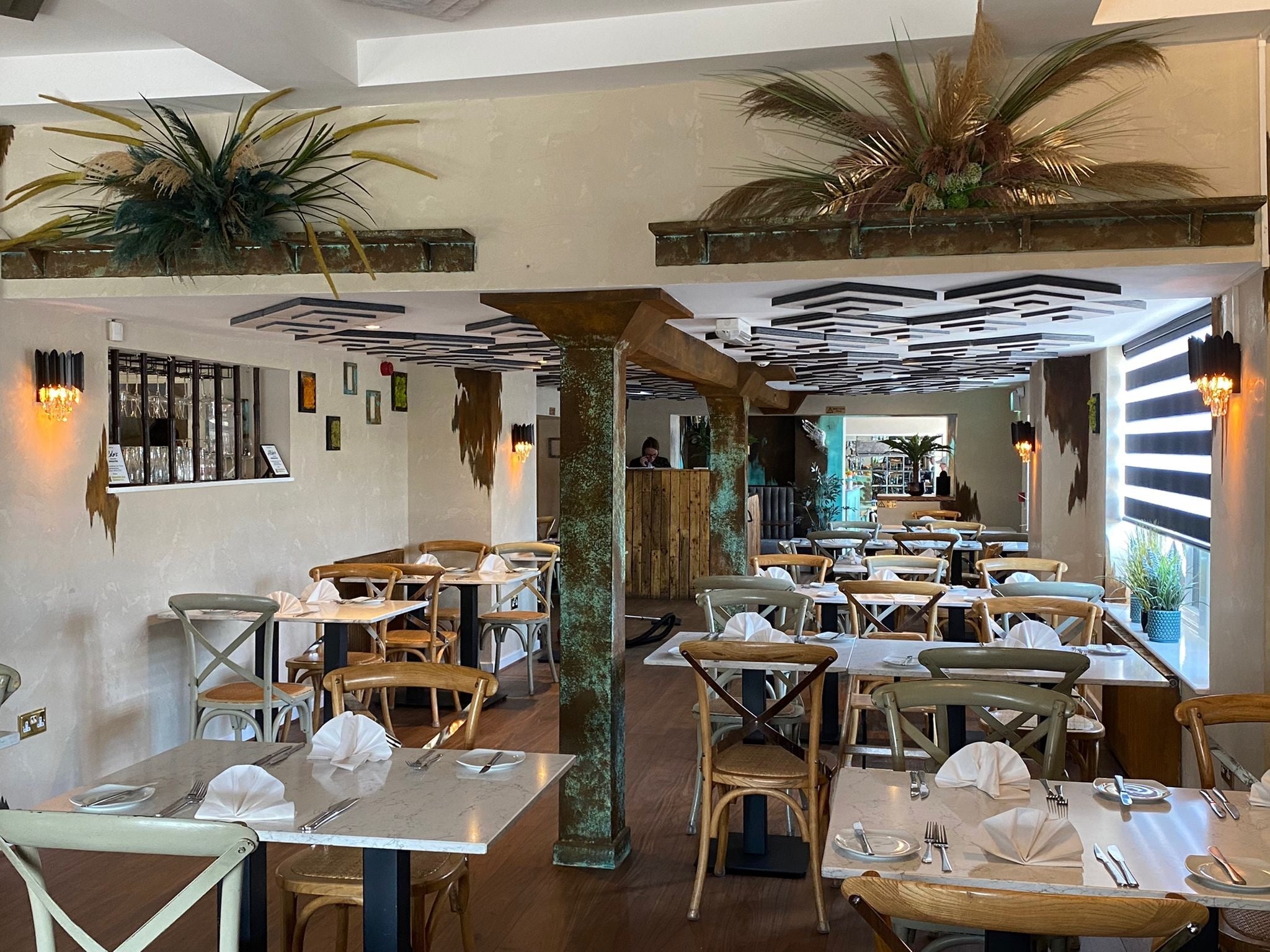 Large hospitality dining area enhanced by warm ambient glow from Doral wall lights