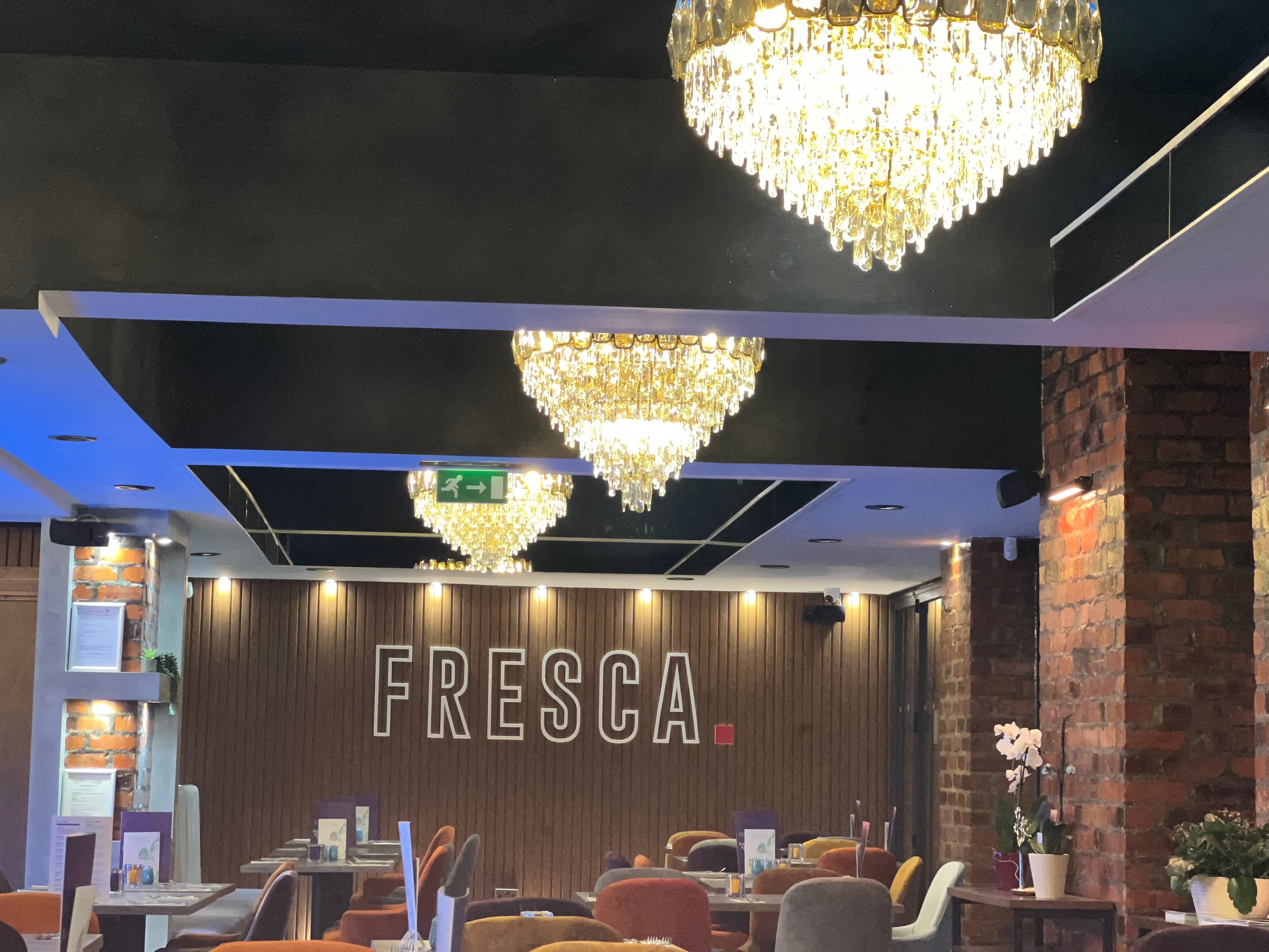 VORELLI Edmond circular chandelier with cascading diamond-cut crystals in luxury restaurant interior