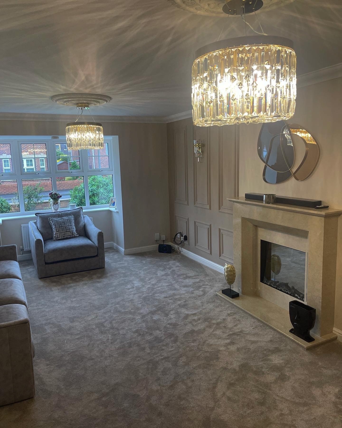 Round crystal ceiling chandelier creating refined atmosphere in a contemporary living space