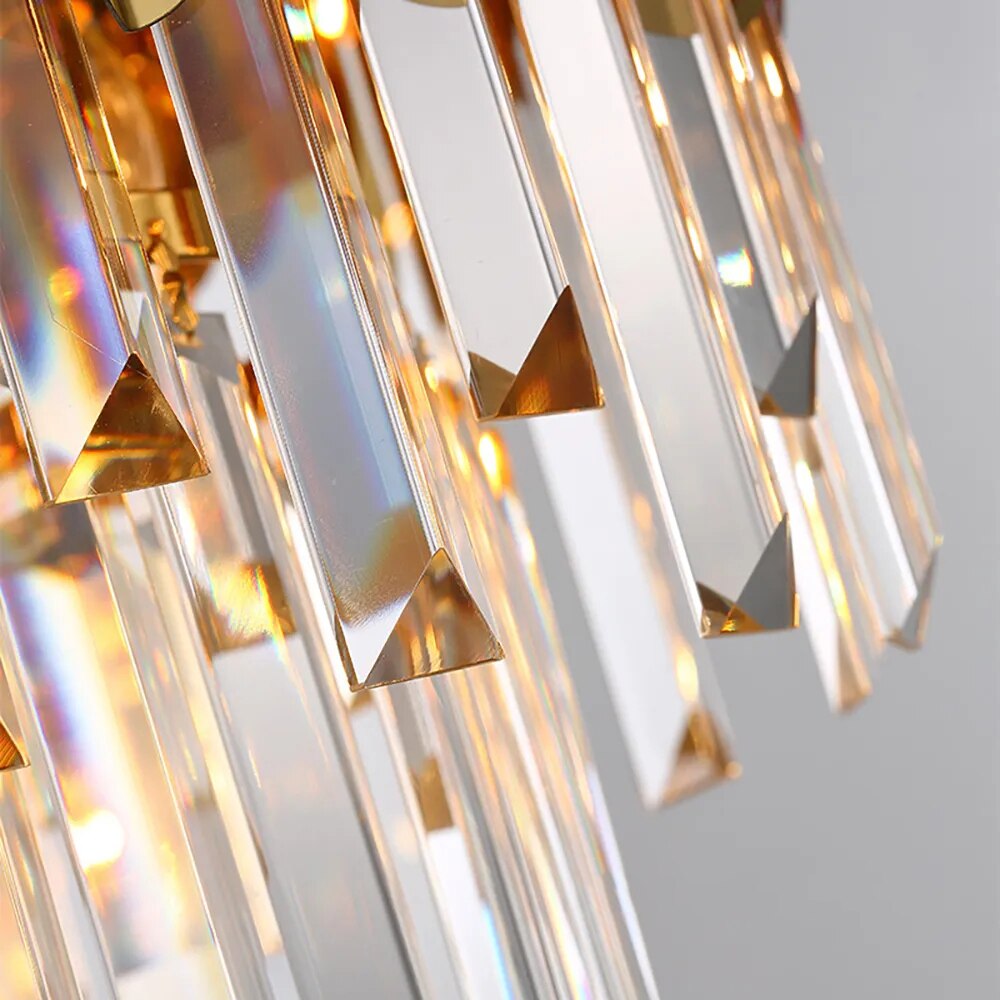Macro detail of VORELLI Manhattan Circular Chandelier II diamond-cut crystal bars with warm illumination