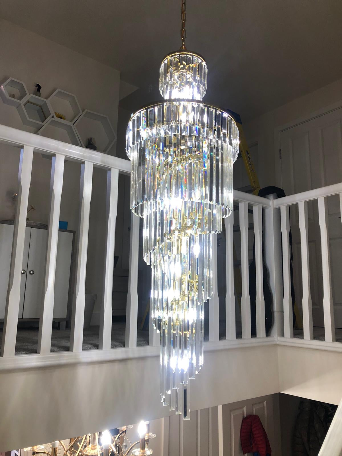 Close-up of diamond-cut crystal tiers forming a cascading spiral chandelier design.