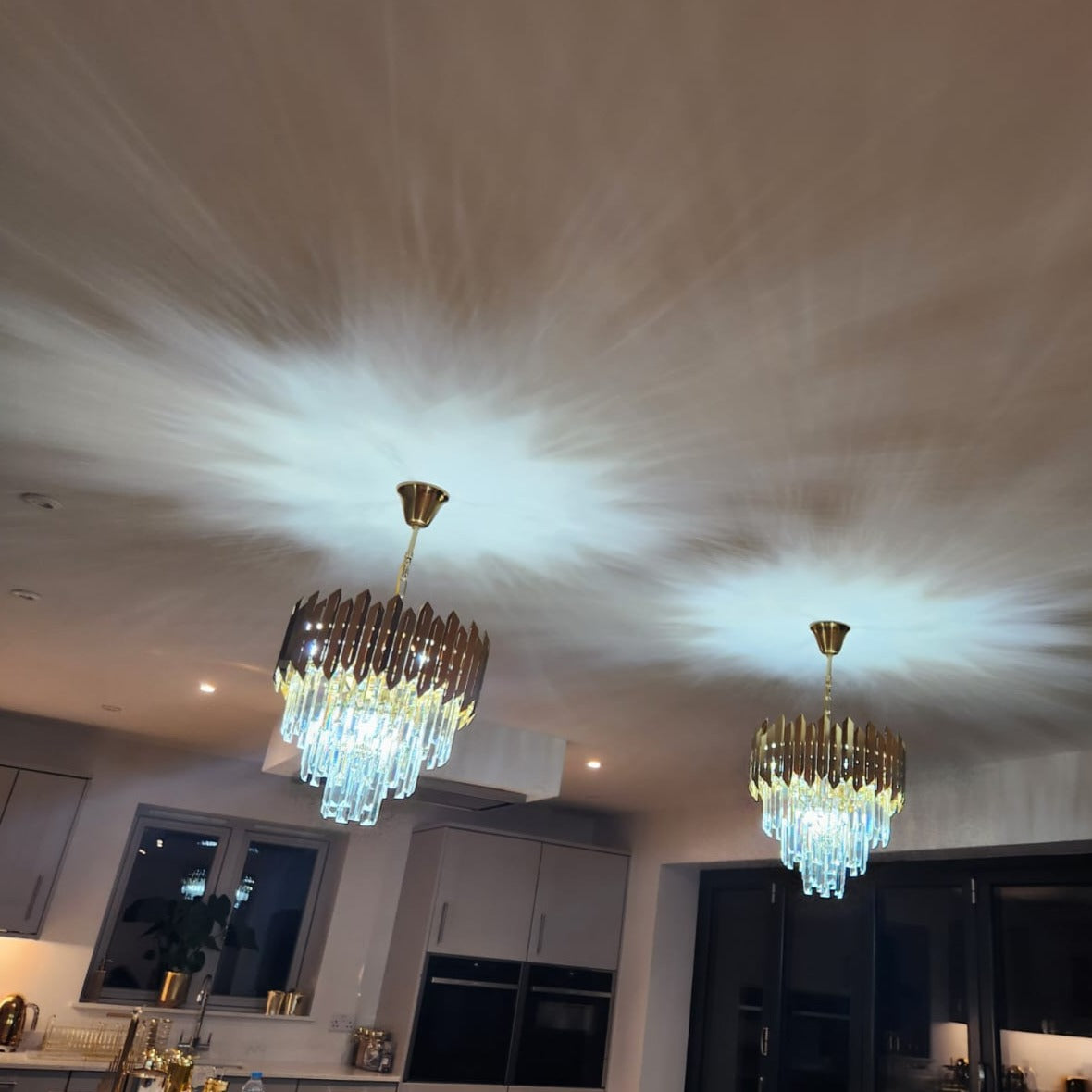 Two VORELLI Manhattan Pendant II lights installed on a ceiling creating soft decorative lighting