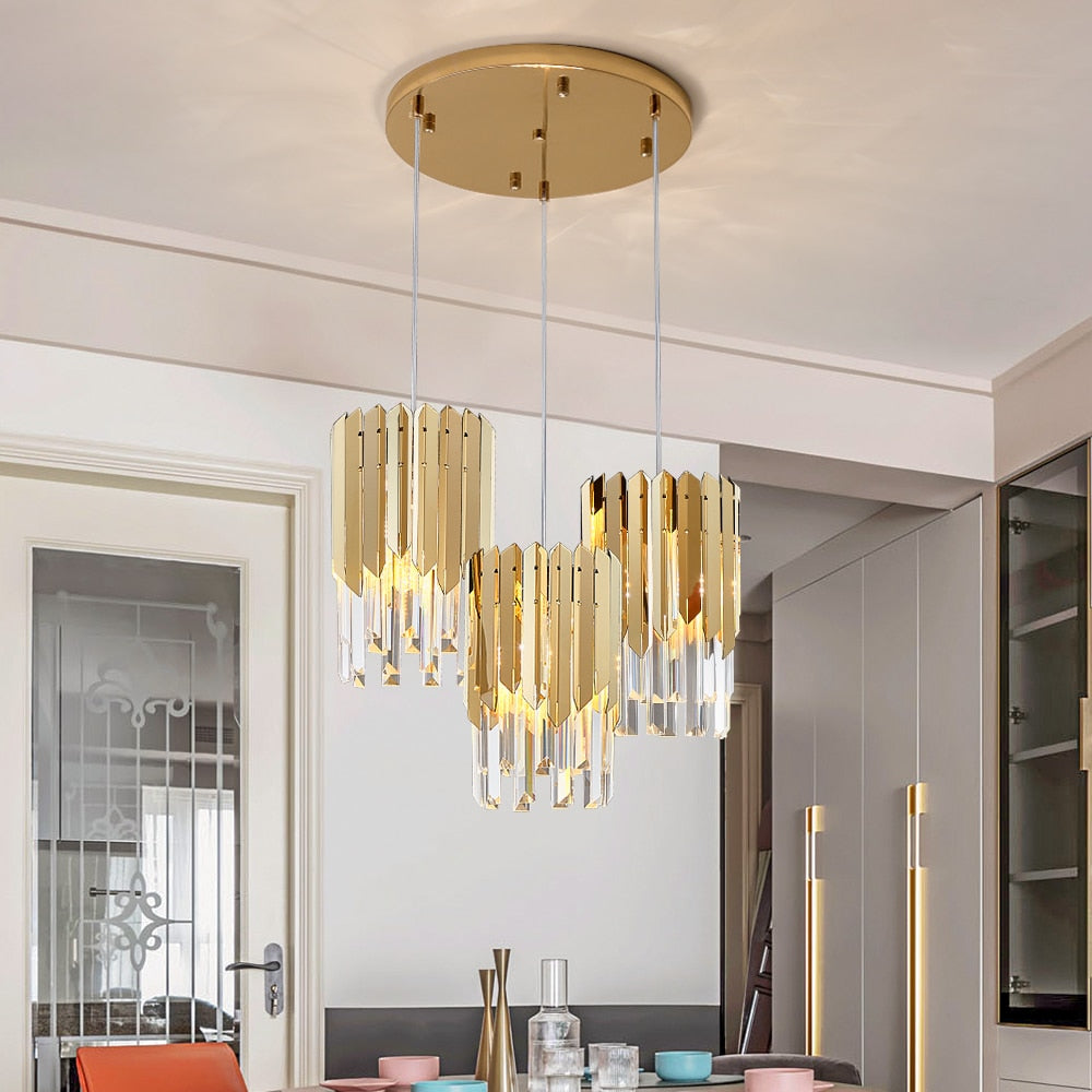 VORELLI Manhattan Pendant Staircase Chandelier with cascading crystal bars and gold frame in a modern staircase interior