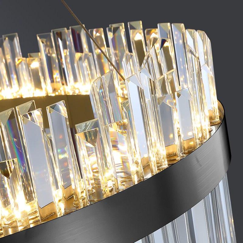 Detailed view of diamond-cut crystal bars rising from the stainless steel ring on the VORELLI Medina circular chandelier