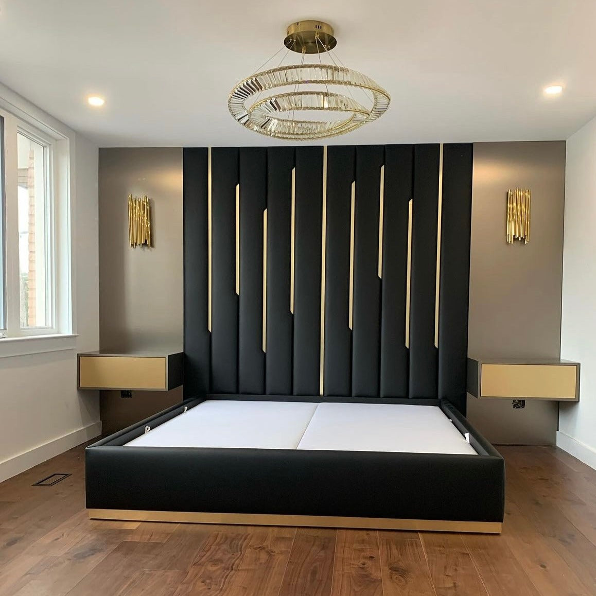 Elegant VORELLI Melia double circular crystal chandelier illuminating a modern luxury bedroom