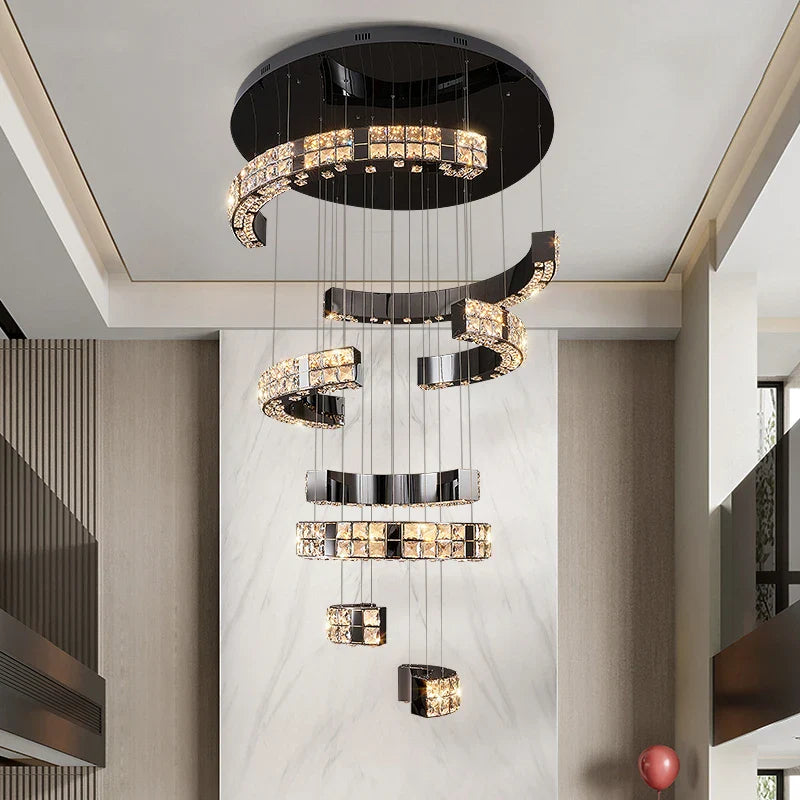 Tiered crystal VORELLI® Minato staircase chandelier enhancing a refined architectural space with elegant suspended illumination