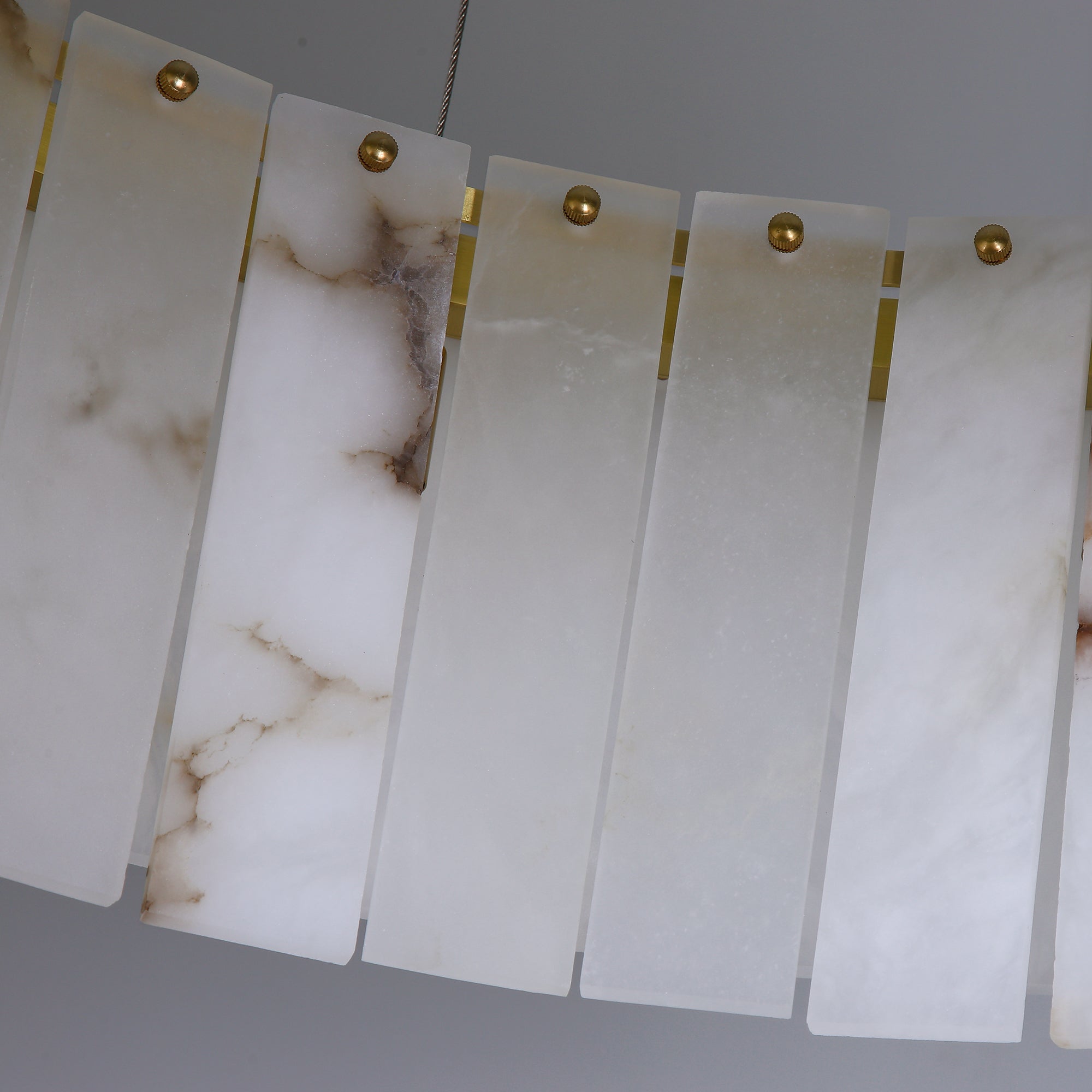 Detailed view of hand cut marble panels on VORELLI® Munro rectangular chandelier
