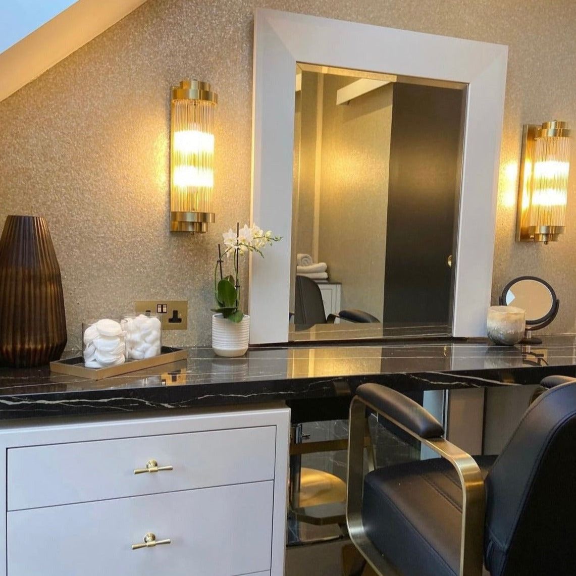Pair of VORELLI® Mykonos cylindrical wall lights installed symmetrically in upscale interior