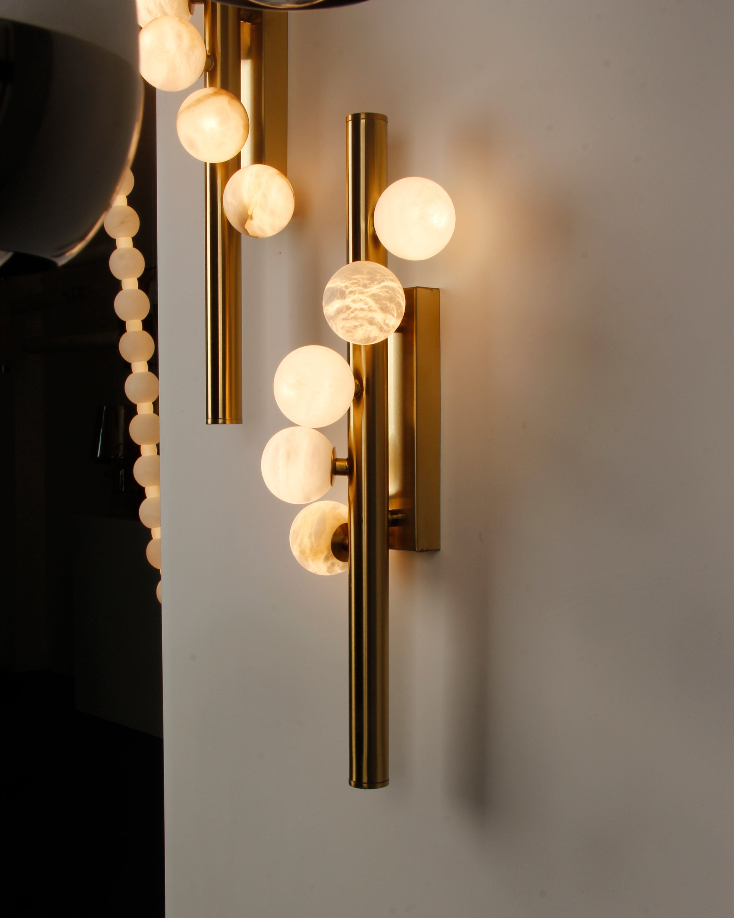 VORELLI® Orbit luxury marble wall light enhancing refined interior with vertical globe arrangement
