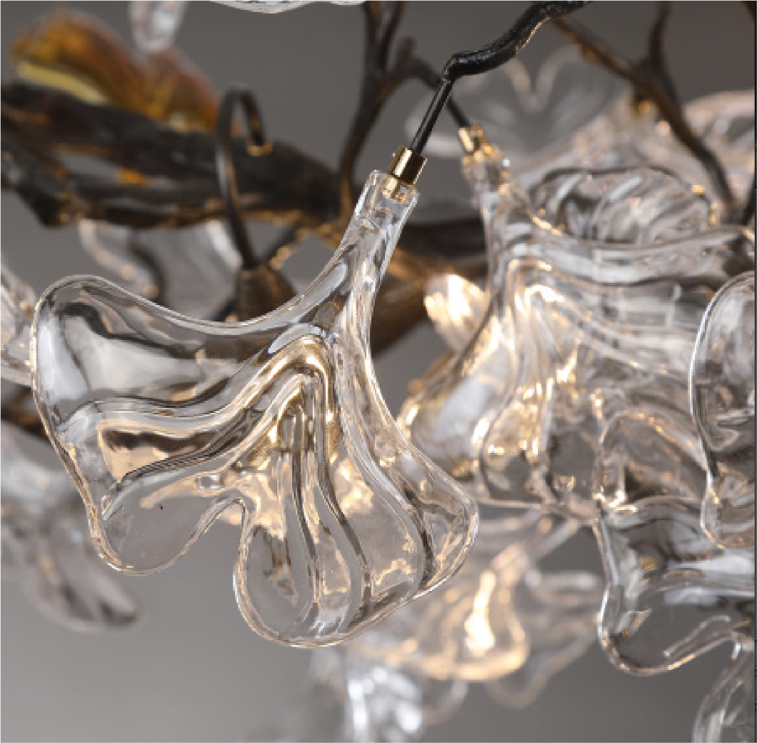 Close-up of sculpted glass leaves on the Prano Rectangular Chandelier II by VORELLI®