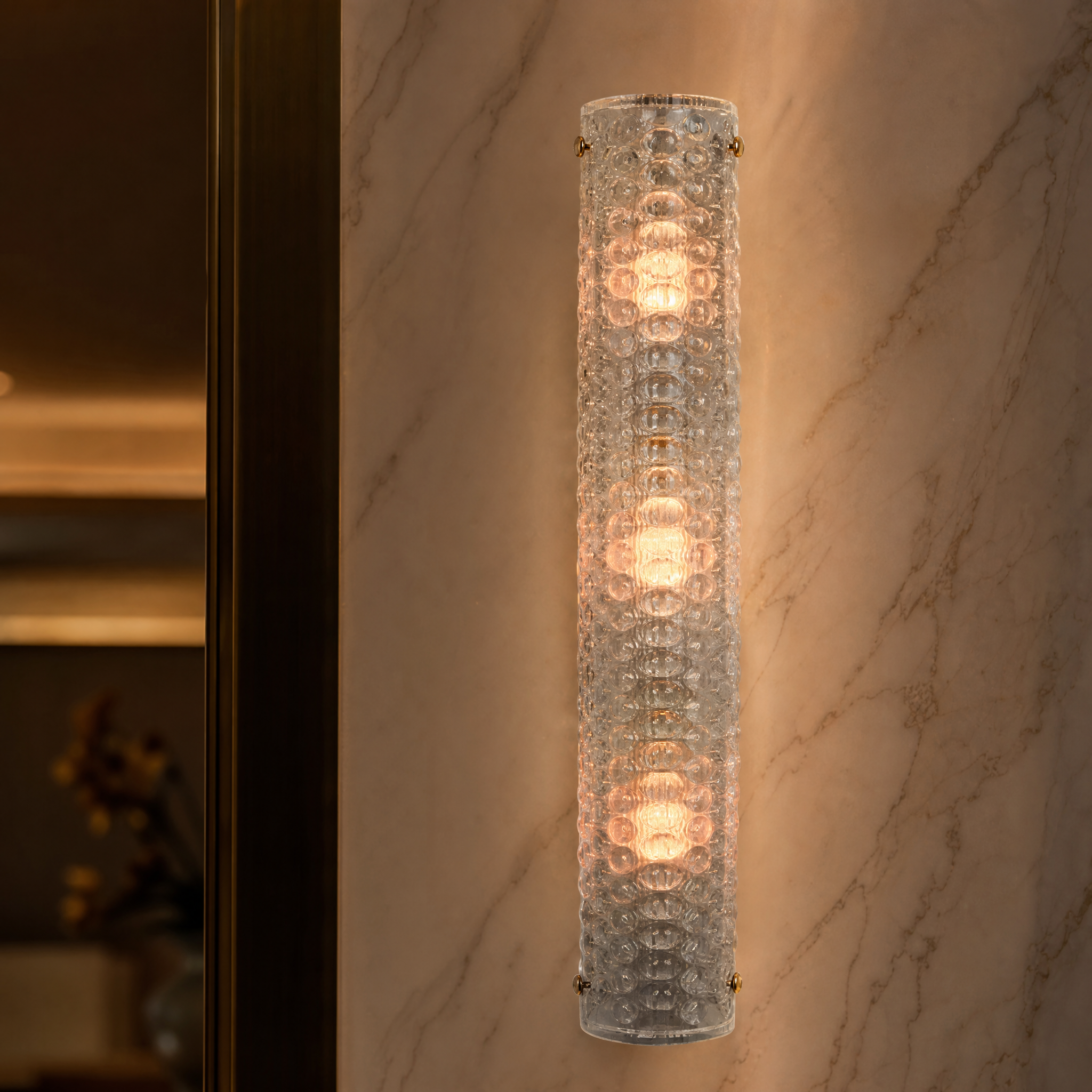 A detailed closeup of the VORELLI Rapino wall light, highlighting the rich texture of the sea green moulded glass shade and industrial brass bolt accents.