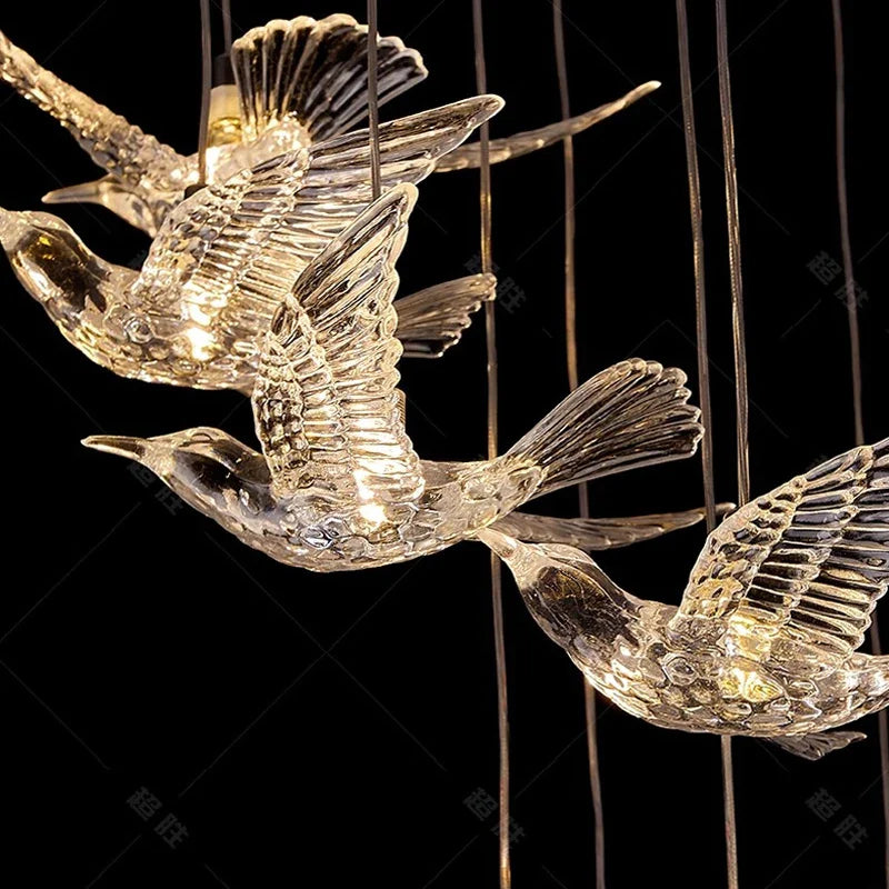 Ambient luxury staircase lighting with suspended glowing birds creating a dramatic architectural focal point