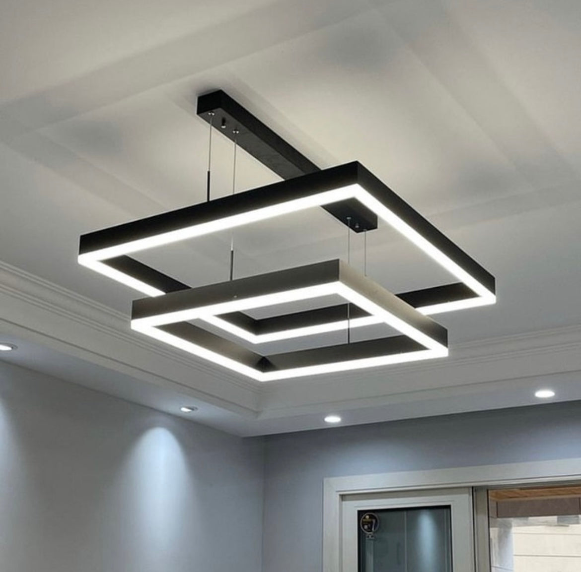 Minimalist double frame chandelier with LED lighting enhancing clean contemporary interior